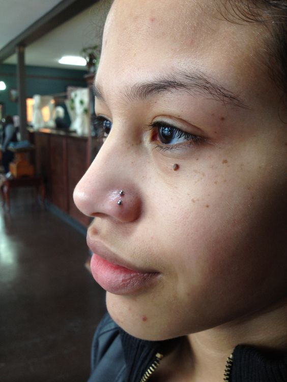 Side view of a lady showing off her cute piercing