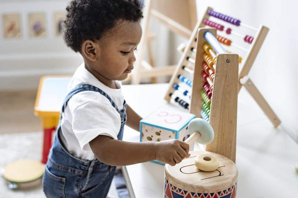 African american boy is playing using the montessori method and toys.