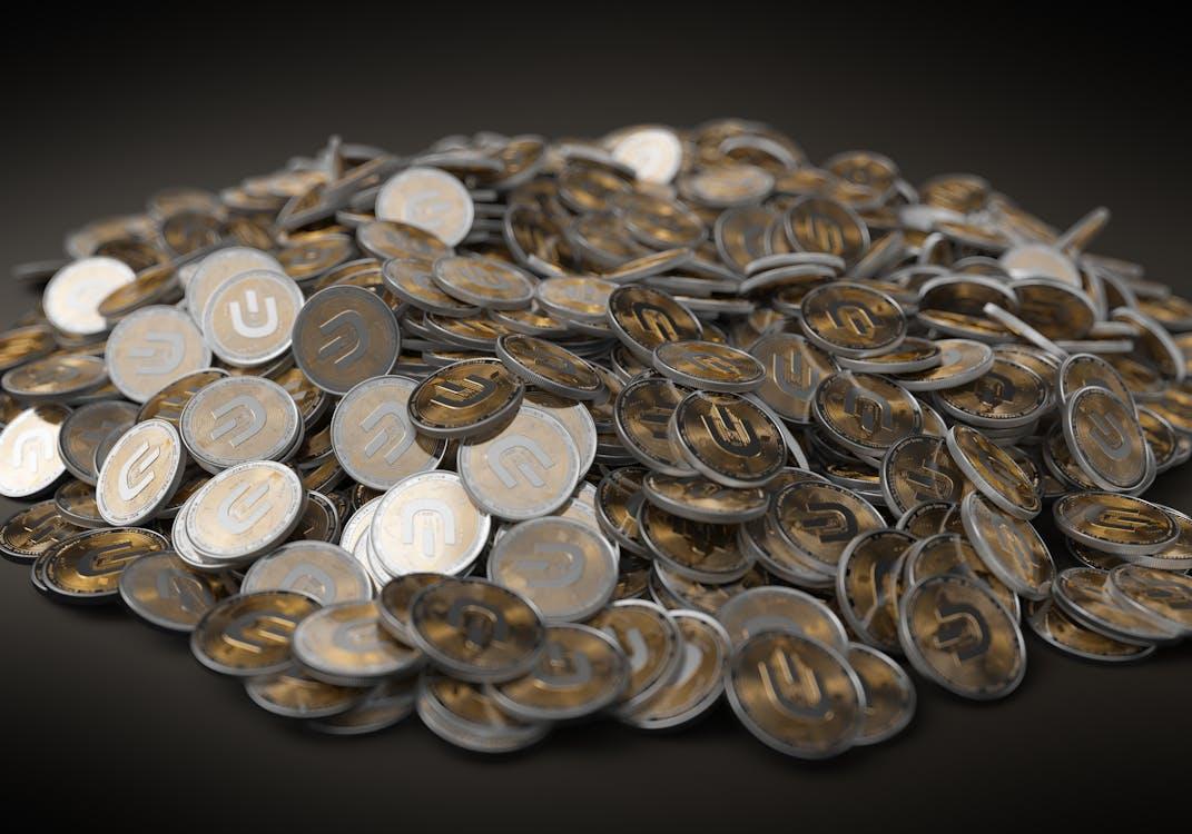 Free A Pile of Silver and Gold Round Coins Stock Photo