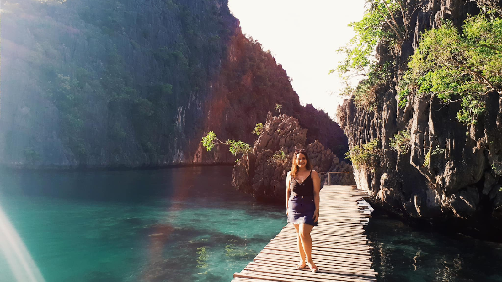 A lady tourist standing at the wooden path of Kayangan Lake in Coron, Philippines.