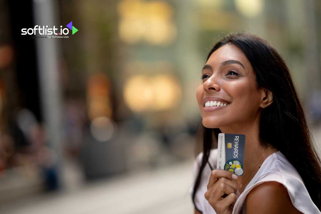 Smiling woman holding rewards card, outdoor setting