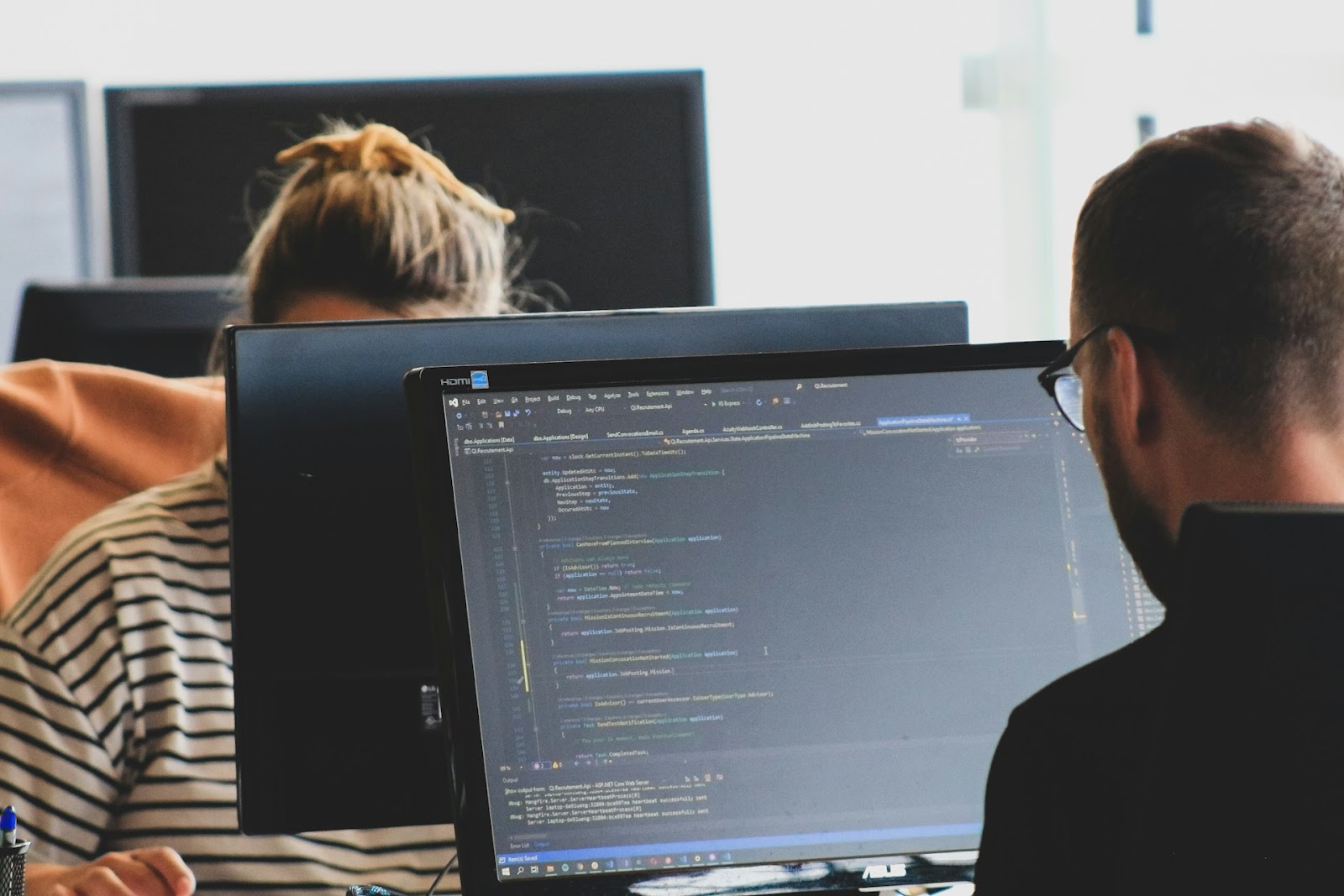 Two employees working on their computers.