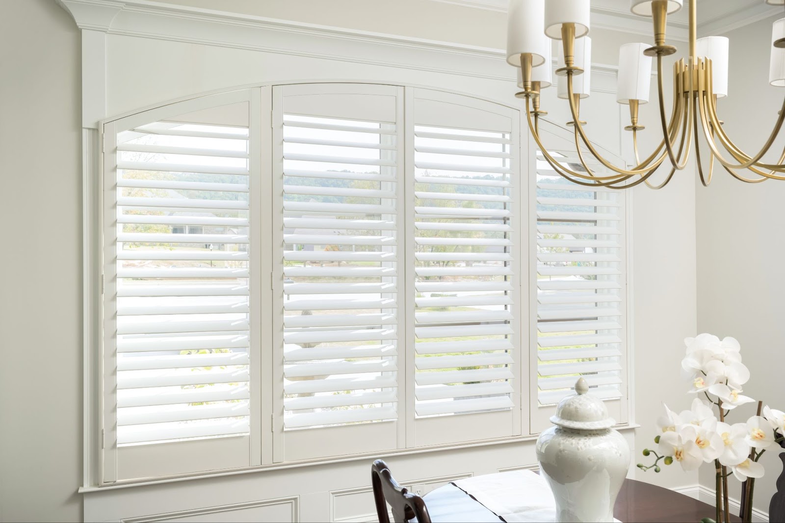 Custom white shutters in the dining room of a Chattanooga home