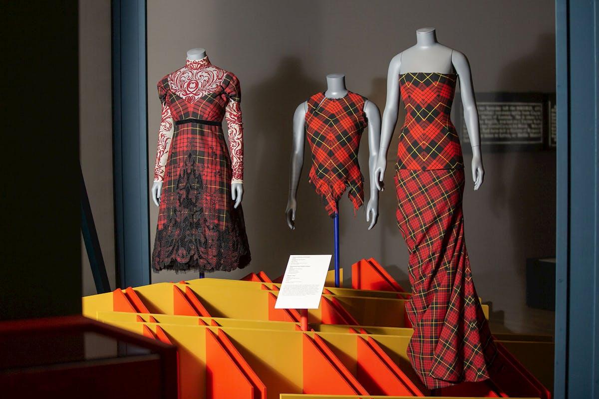 Three dresses by Alexander McQueen on display in Tartan at V&A Dundee
