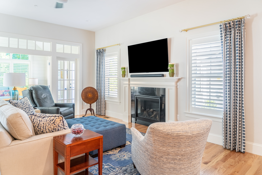 Beach house with living room view and wooden shutters on windows 