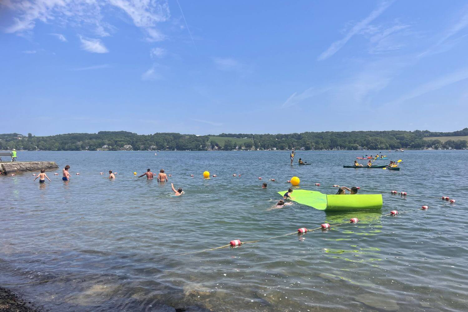 Youth athletes at overnight sports camp enjoying water activities on Keuka Lake