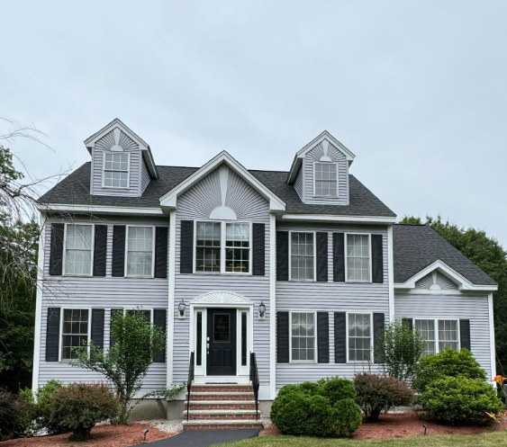 A house with a black door and a black door

Description automatically generated