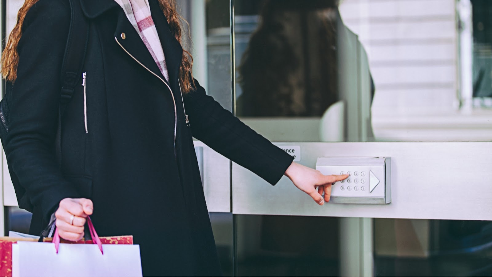 A building employee uses a keypad lock to gain access to a building.