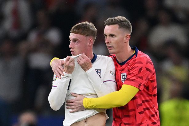 Cole Palmer of England is consoled by Dean Henderson