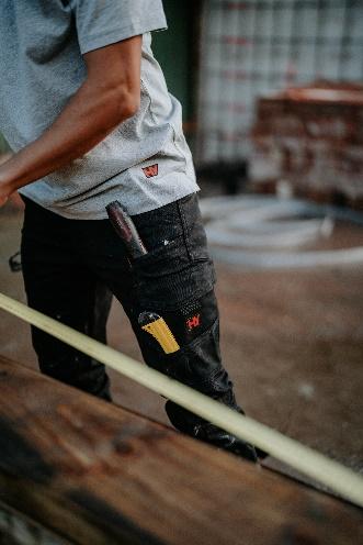 A person wearing a grey shirt and black pants

Description automatically generated