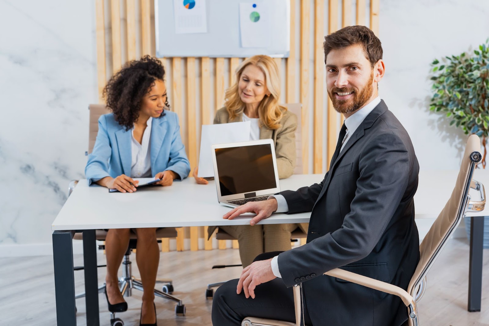 A group of businesspeople having a meeting in a room.