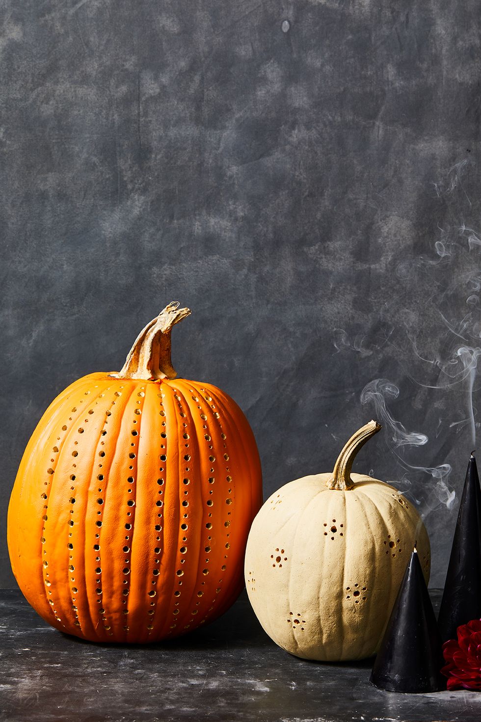 pumpkin carving ideas, one orange and another white drilled pumpkin