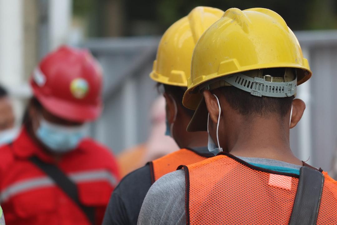 Workers on a building site with masks and helmets