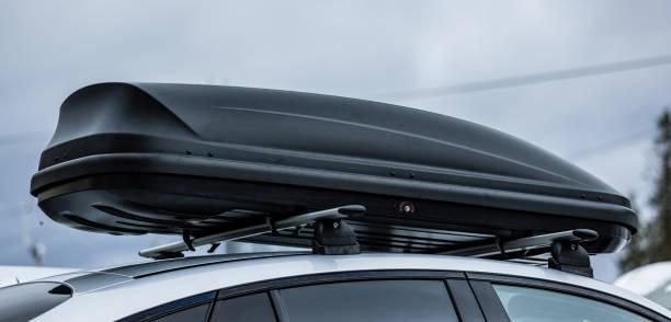 Roof rack with cargo box in winter Roof rack with cargo box on car roof in winter. R1S Roof Rack stock pictures, royalty-free photos & images