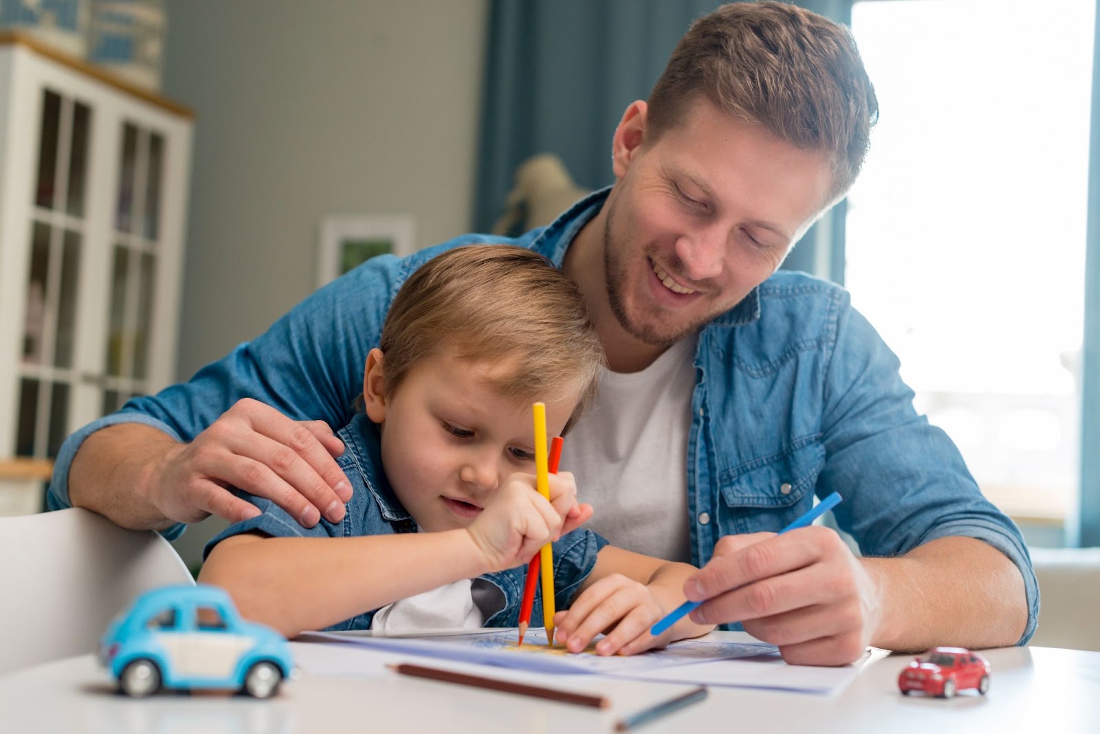 A father and a son doing fun colouring activities.