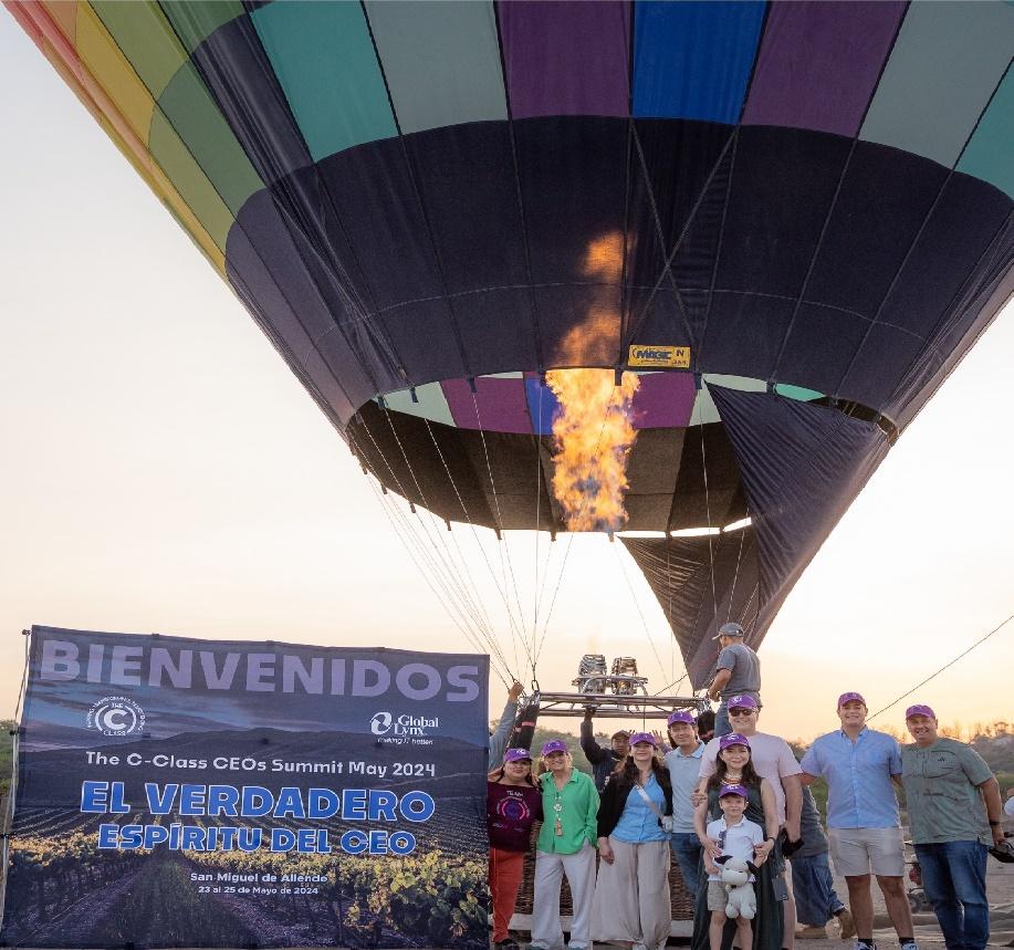 A group of people standing in front of a hot air balloon

Description automatically generated