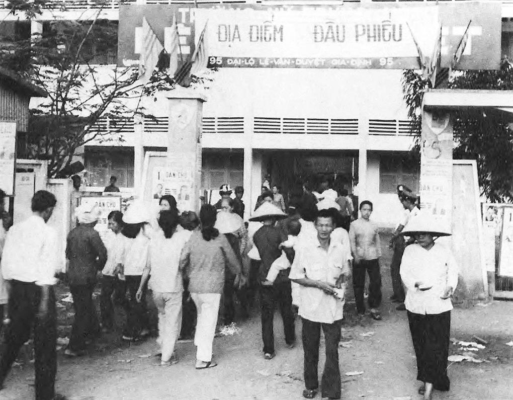 A group of people walking in front of a building