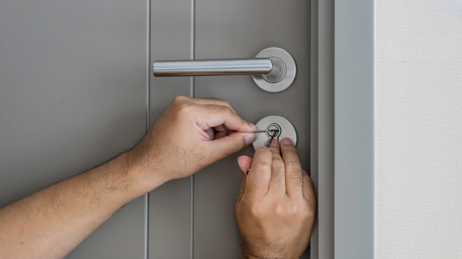 Using tools to perform broken key removal from a residential door lock.