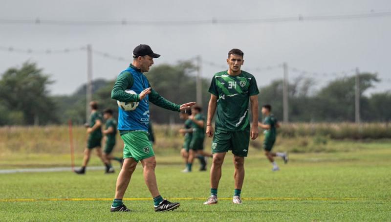 A group of men in green uniforms on a fieldDescription automatically generated