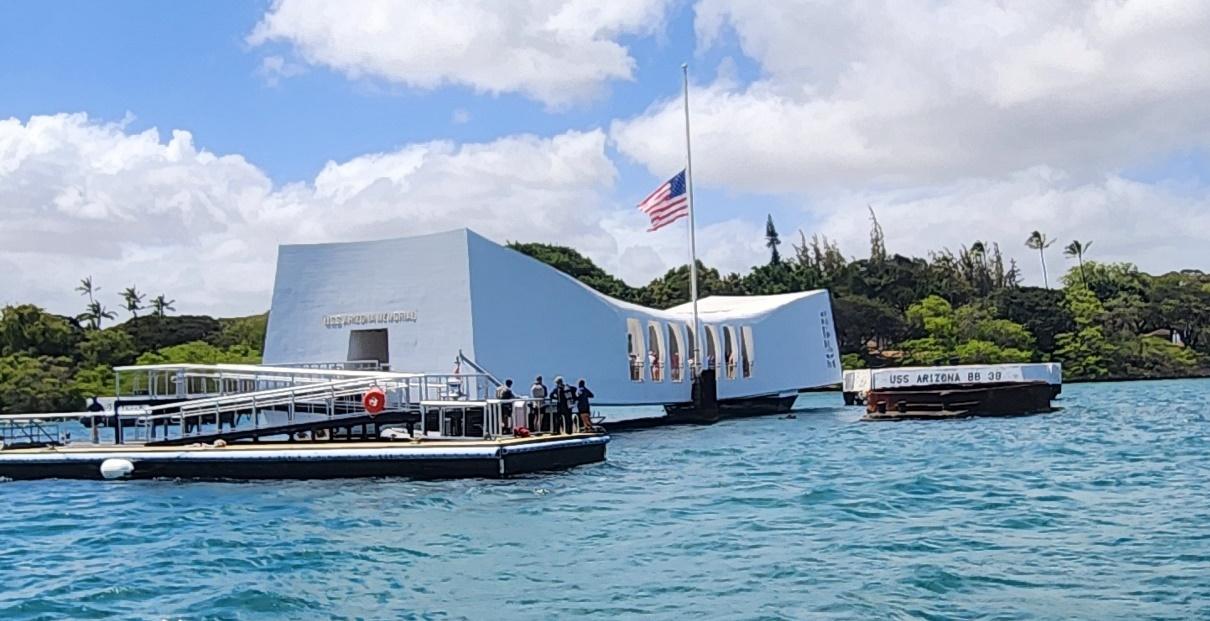 A white building with a flag on it

Description automatically generated