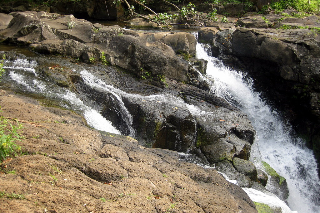 Clean and clear water flowing down on rocks
