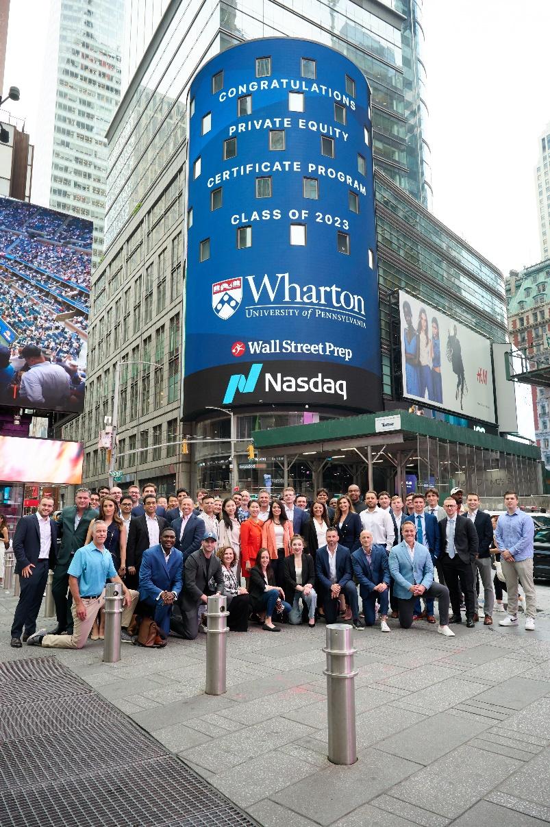 A group of people standing in front of a large building

Description automatically generated