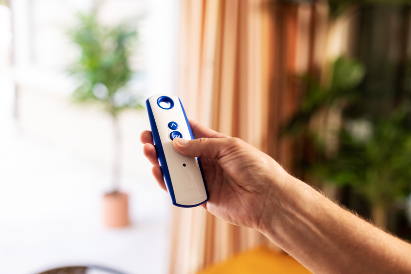 Hand holding a window control remote