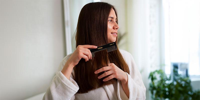 A person brushing her hair

Description automatically generated