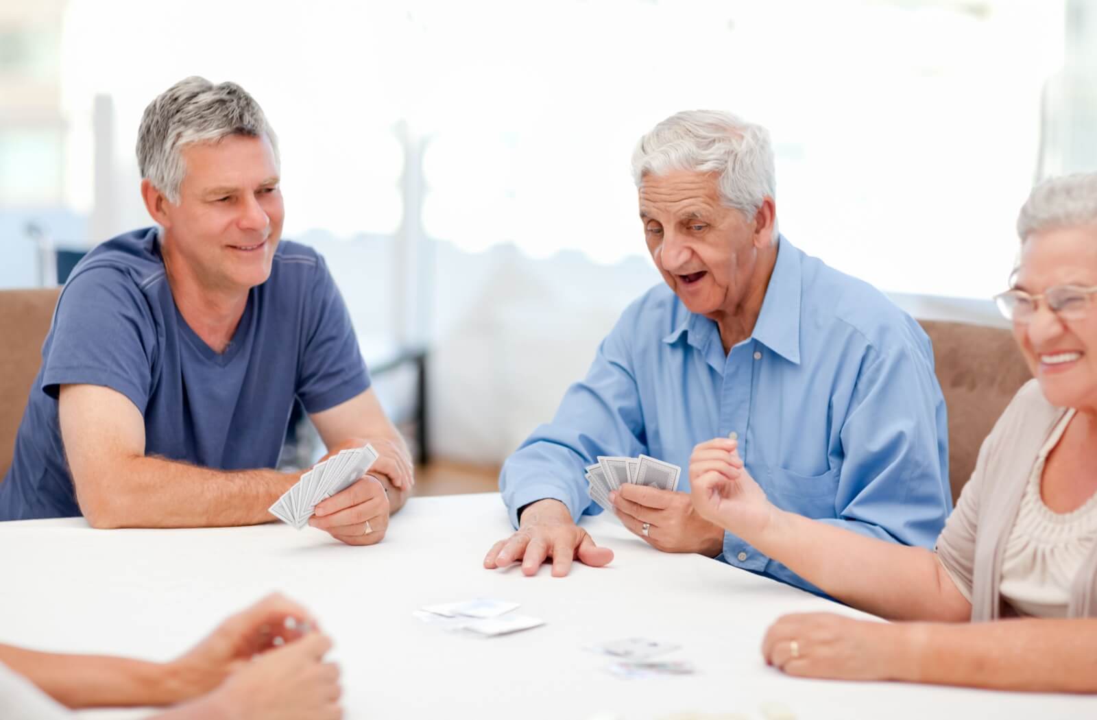 A group of older adults playing cards.