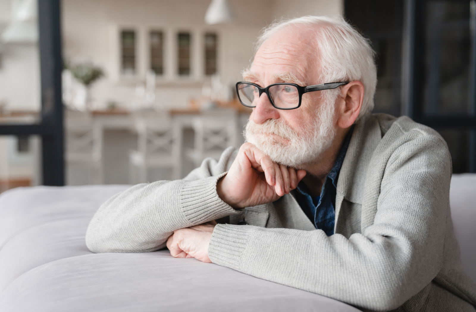 a person is holding a puzzle in the shape of the human mind, with a few pieces missing like those with dementia.