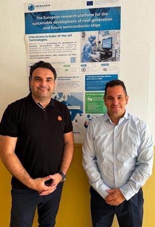 Two men standing in front of a poster

Description automatically generated