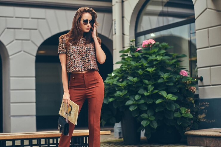 Beautiful fashionable brunette wearing trendy clothing and sunglasses