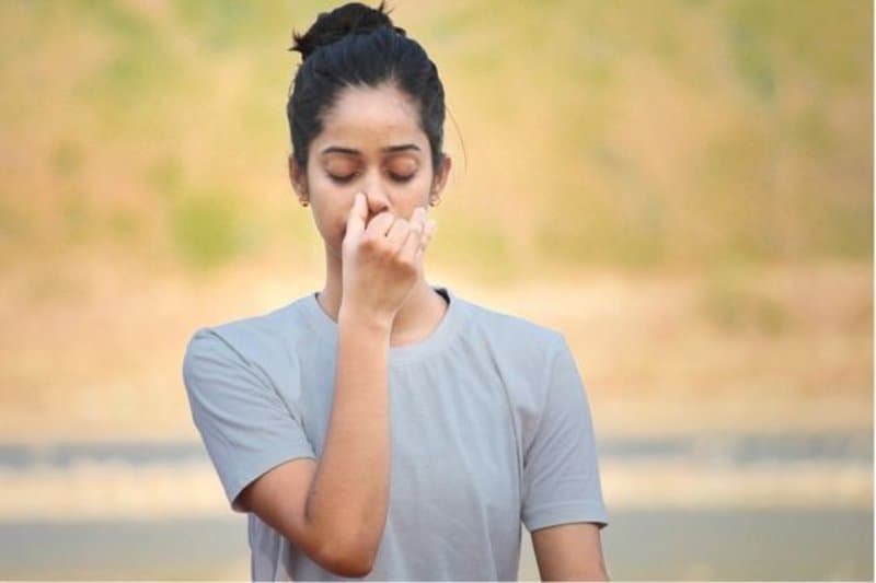 woman doing one of the types of pranayama breathing technique