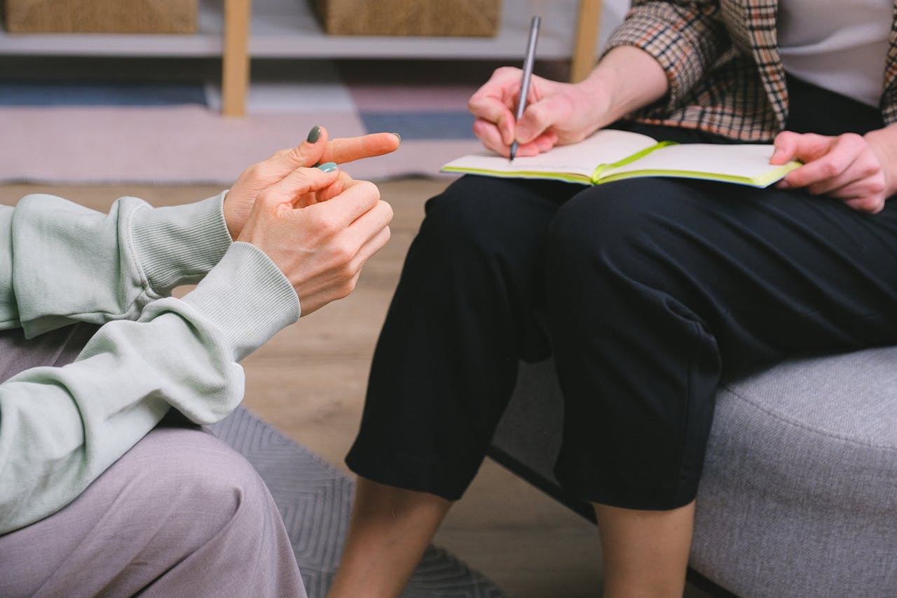 two people sitting and having an in person talk therapy session