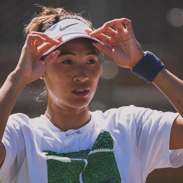 Photo by Zheng Qinwen in Wimbledon. May be an image of 1 person, playing tennis, racket, sports equipment and text.