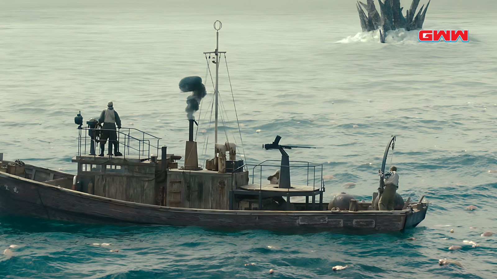 Fishermen on a boat near Godzilla's spiky back.