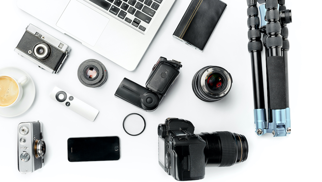 Multiple photography essentials laid out on a white counter