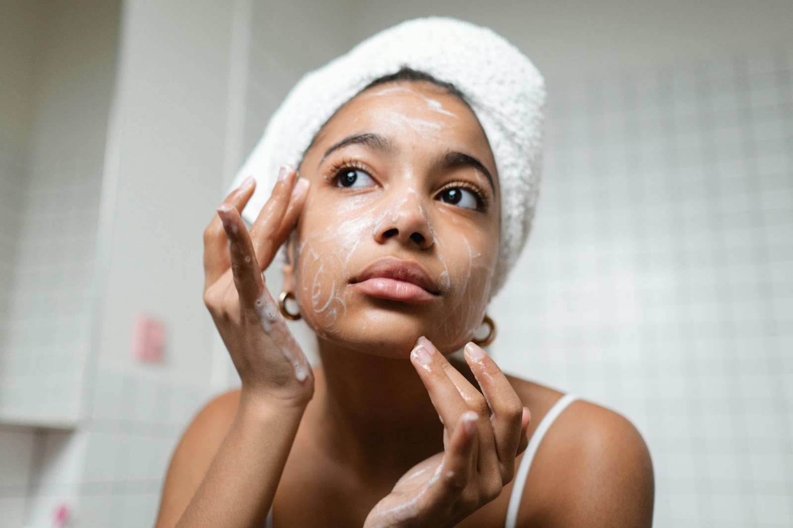 Attractive young black lady using a natural, DIY cleansing scrub for her face