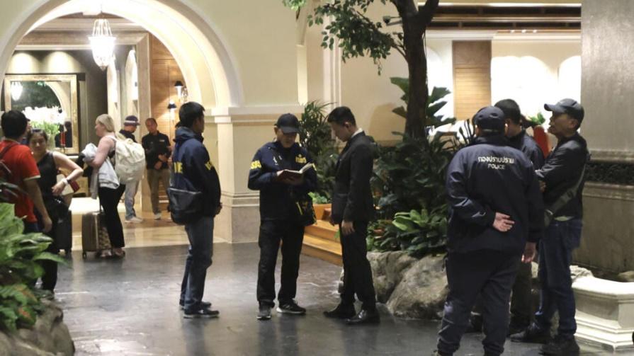 Police officers talk to a staff member at the Grand Hyatt Erawan Hotel in Bangkok, Thailand, Tuesday, July 16, 2024. Police said a number of people were found dead Tuesday in the luxury hotel in downt