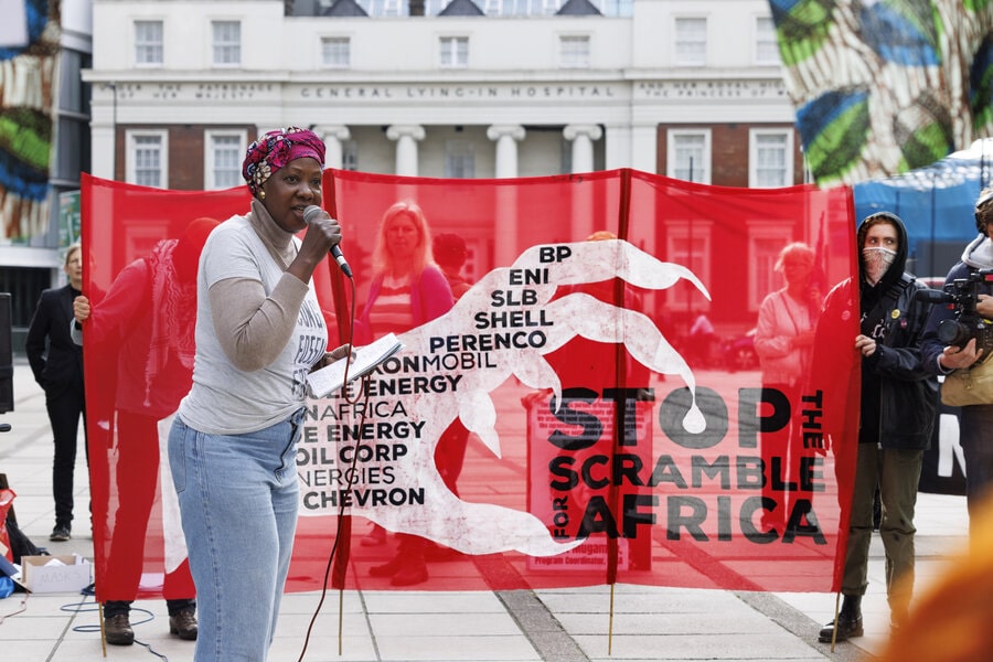 An African activist talks outside the African Energies summit in London