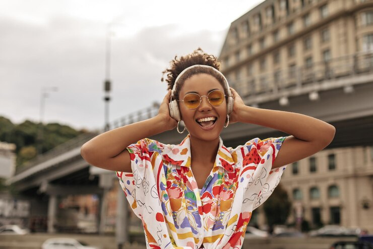 Woman smiling while listing to music on headphones