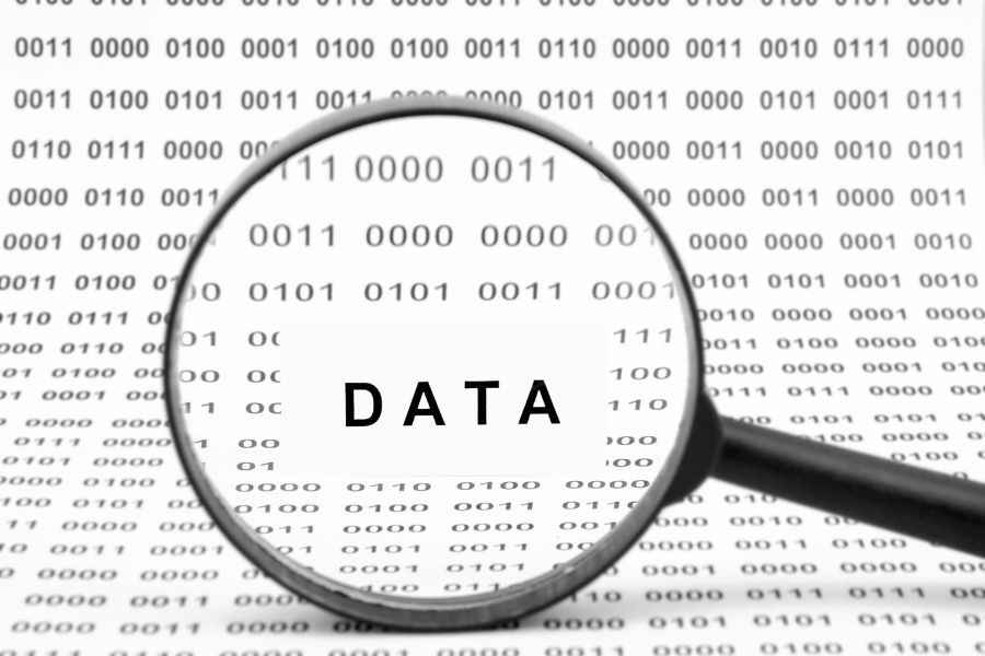 A magnifying glass over a binary code