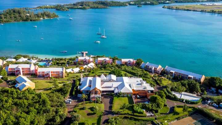 Top view of Bermuda also known as one of the safest Caribbean Islands showcasing turquoise water and small houses.