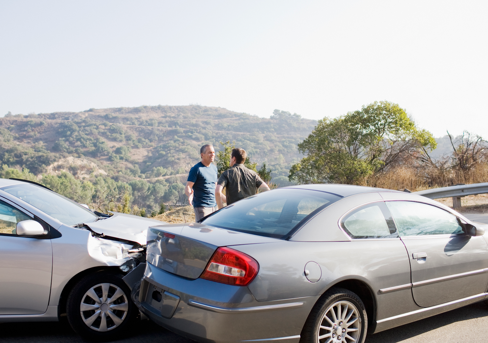 Car accident in Virginia, men discussing auto insurance coverage and liability insurance financial protection at the scene of an accident