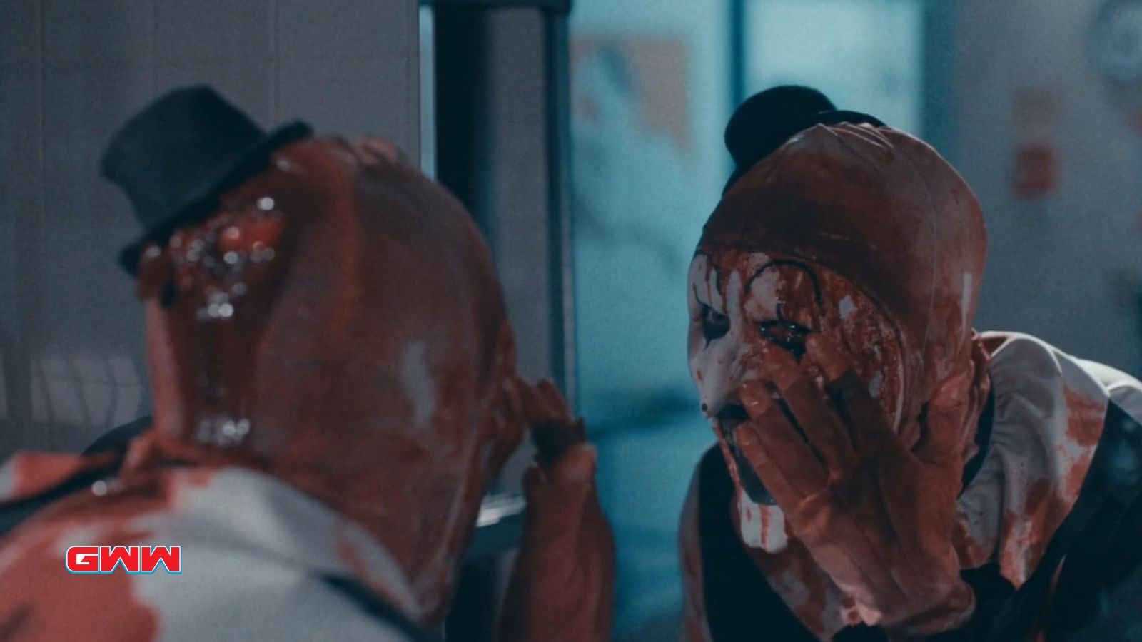 Art the Clown looking at the his eye on the mirror, cast of Terrifier 3