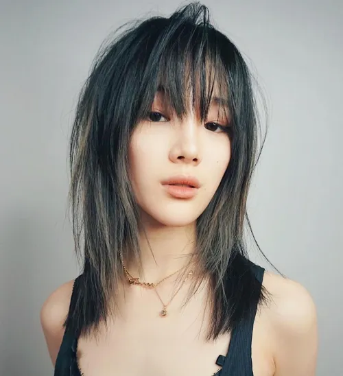 Picture of  a lady wearing the Mid-Length Wolf Cut with Choppy Layers