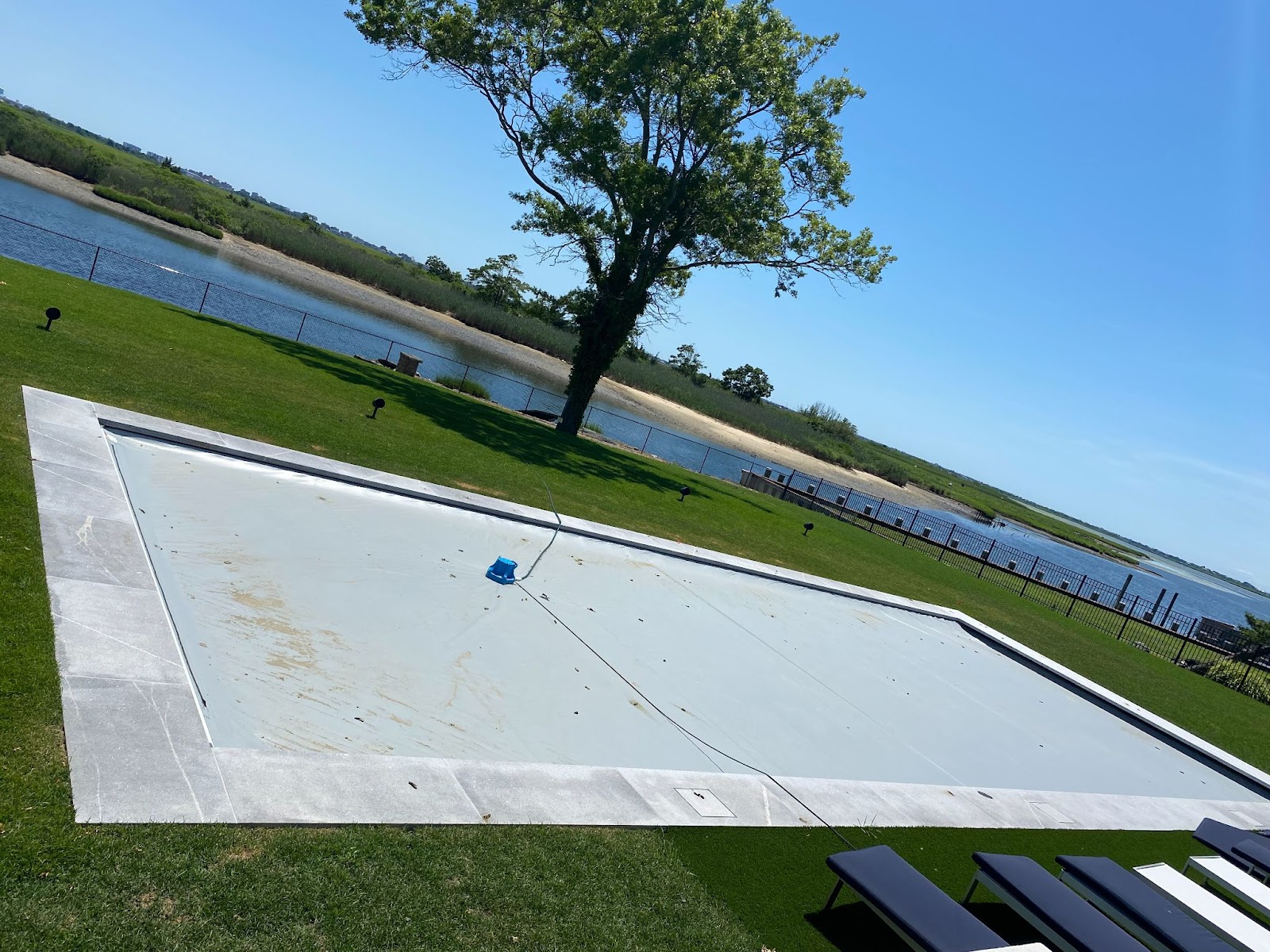 New pool install on the water with granite pool coping