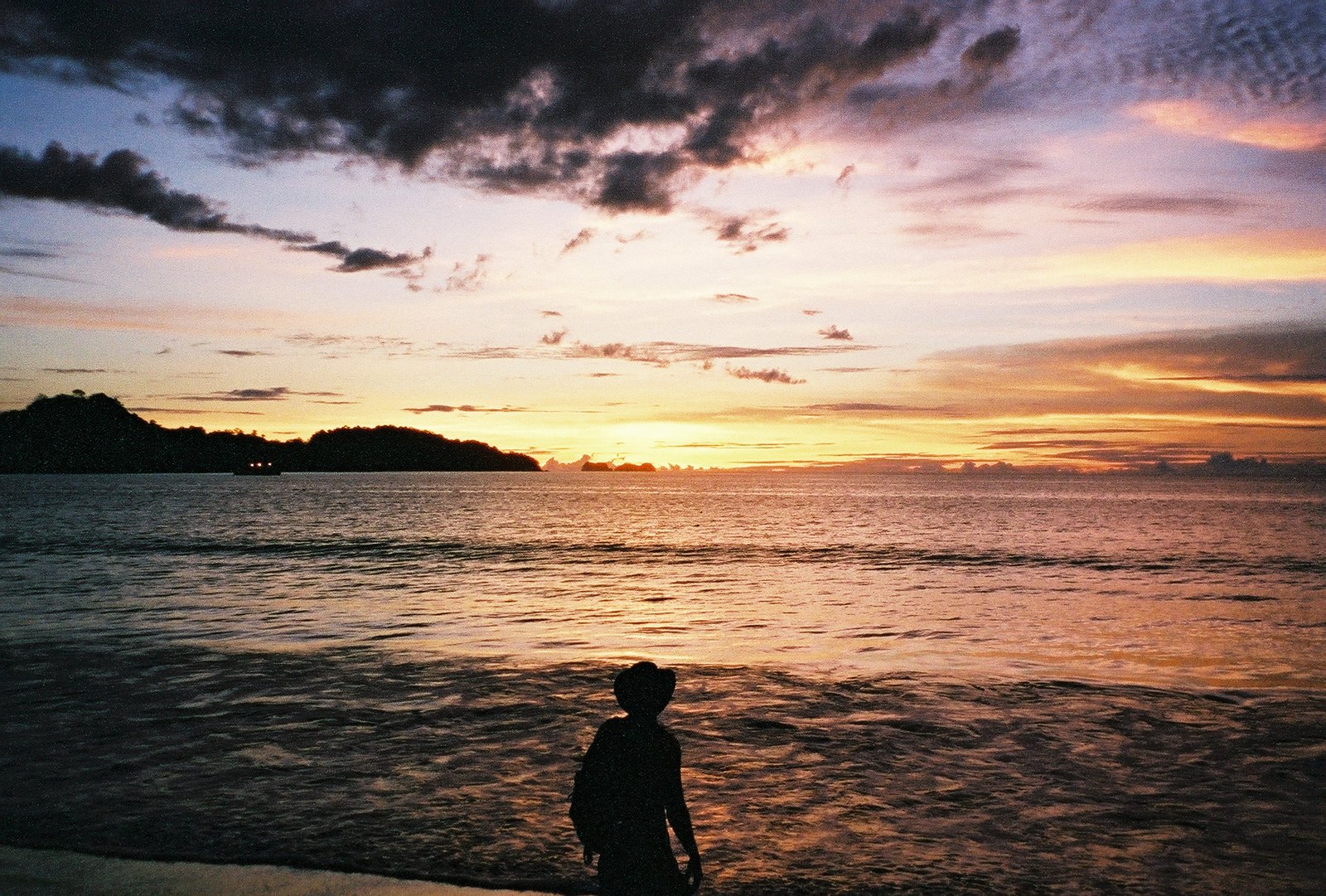 a man in a cowboy hat adoring the sunset in one of the best beaches in Costa Rica