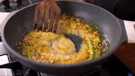 Onion paste turning golden brown as it cooks in a pan, creating a rich base for the masala.