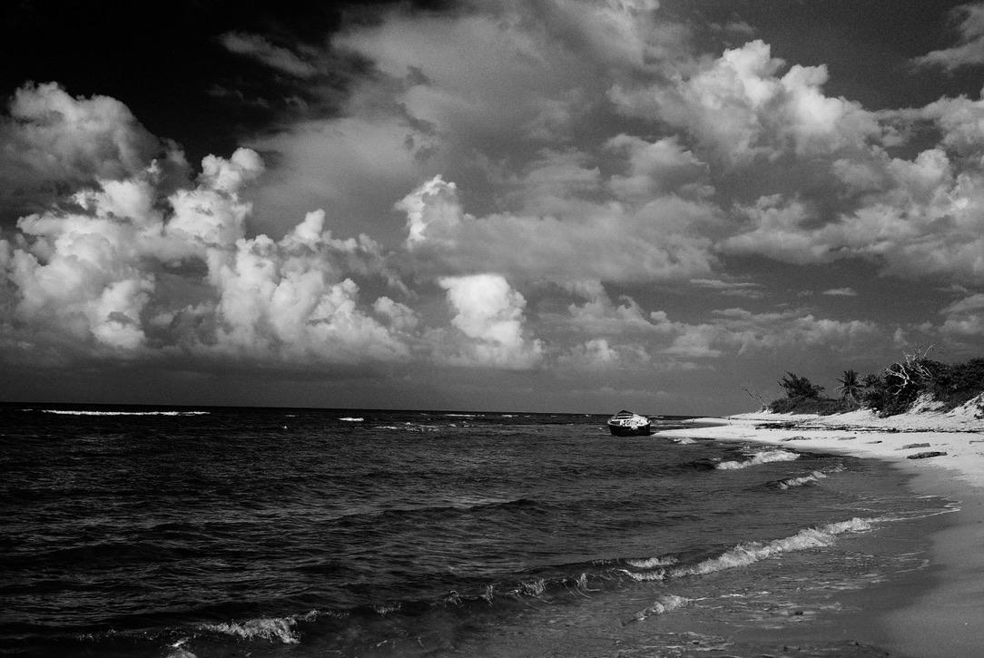 A black and white photo of a beach

Description automatically generated